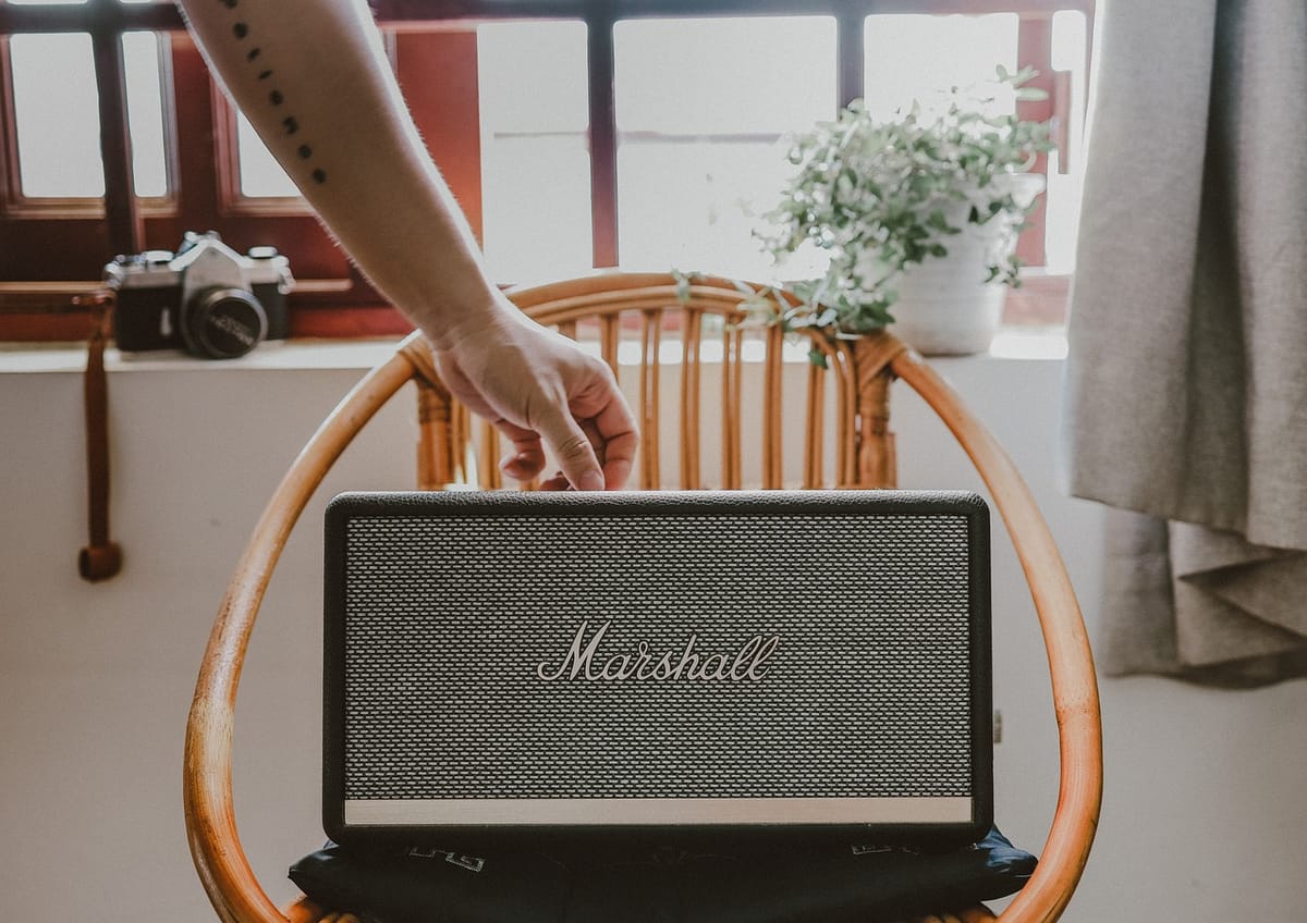 A picture of a Marshall guitar speaker on a wooden chair